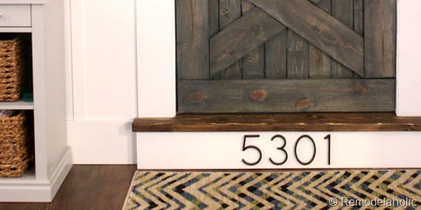 building out stair with wood bullnose and house numbers under barn door (16)