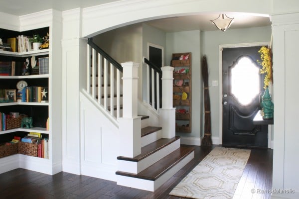 Living Room Remodel with yellow accents wood floors and built-in bookcases and columns with arches-30