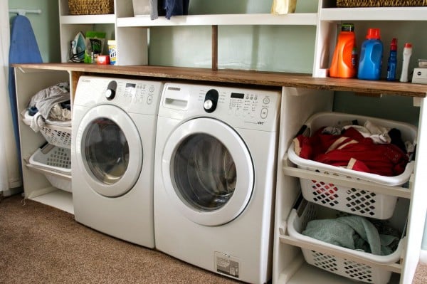 tilted laundry basket storage in laundry unit, Seesaws and Sawhorses on Remodelaholic